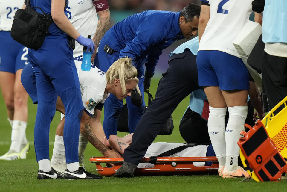 England's Rachel Daly, left, checks on England's Keira Walsh who reacts after getting injured during the Women's World Cup Group D soccer match between England and Denmark at the Sydney Football Stadium in Sydney, Australia, Friday, July 28, 2023. (AP Photo/Rick Rycroft)