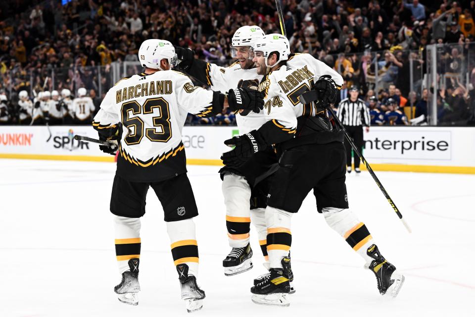 BOSTON, MASSACHUSETTS - NOVEMBER 07: Patrice Bergeron #37 of the Boston Bruins celebrates with Brad Marchand #63 and Jake DeBrusk #74 after scoring a goal against the St. Louis Blues during the third period at the TD Garden on November 07, 2022 in Boston, Massachusetts. (Photo by Brian Fluharty/Getty Images)