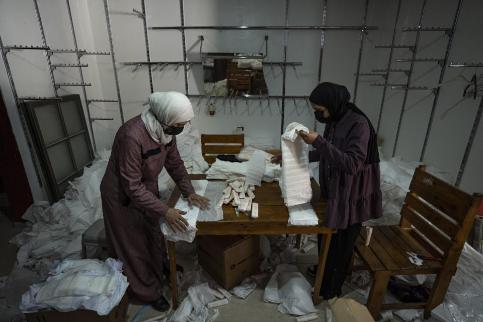 Palestinian women sew diapers in Rafah, southern Gaza Strip, Thursday, Feb. 15, 2024. Palestinians in Gaza have experienced severe shortages of basic necessities since the war began on Oct. 7. (AP Photo/Fatima Shbair)