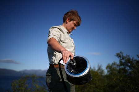 Nina Lindstrom Friggens, a researcher at the University of Stirling, measures the rate of carbon dioxide seeping from the soil at Lake Tornetrask near to the village of Abisko