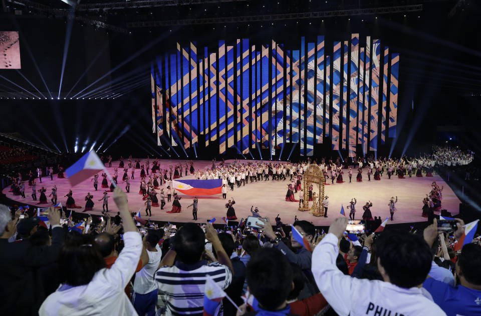 Crowd reacts as the Philippines team walks during the opening ceremony of the 30th South East Asian Games at the Philippine Arena, Bulacan province, northern Philippines on Saturday, Nov. 30, 2019. (AP Photo/Aaron Favila)