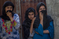 People watch the funeral of Waseem Ahmed, a policeman who was killed in a shootout, on the outskirts of Srinagar, Indian controlled Kashmir, Sunday, June 13, 2021. Two civilians and two police officials were killed in an armed clash in Indian-controlled Kashmir on Saturday, police said, triggering anti-India protests who accused the police of targeting the civilians. (AP Photo/ Dar Yasin)