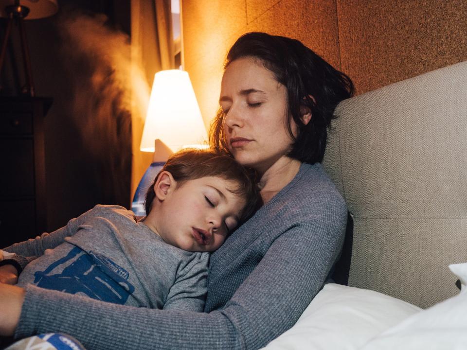 Family sleeping in bedroom