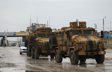 Turkish military vehicles ride at the Bab el-Salam border crossing between the Syrian town of Azaz and the Turkish town of Kilis, in Syria January 1, 2019. Picture taken January 1, 2019. REUTERS/Khalil Ashawi