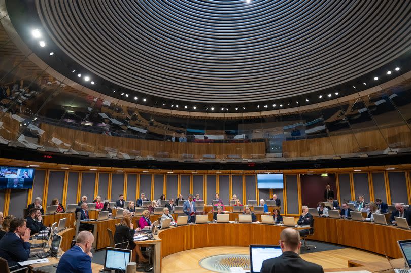 A view of people sat in the Senedd chamber in Cardiff Bay with First Minister Vaughan Gething on his feet