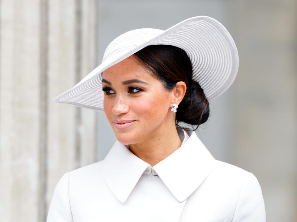 Meghan Markle in a white jacket and hat