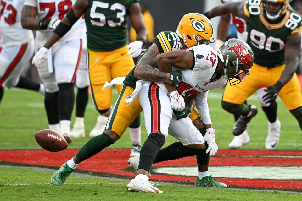 Green Bay Packers' Rasul Douglas hits Tampa Bay Buccaneers' Russell Gage and forces a fumble during the second half of an NFL football game Sunday, Sept. 25, 2022, in Tampa, Fla. (AP Photo/Jason Behnken)