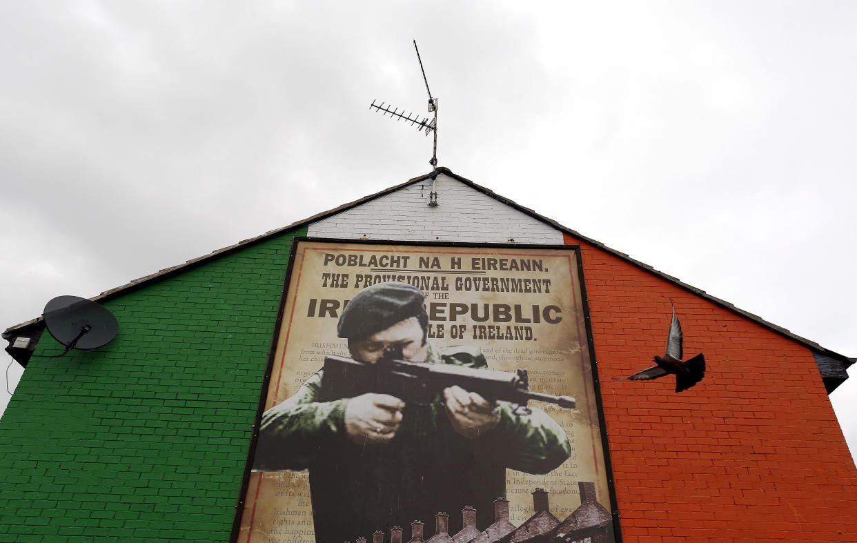 A pigeon flies past a mural supporting the Irish Republican Army (IRA) in the Ardoyne area of north Belfast, September 9, 2015. Britain's secretary of state for Northern Ireland's Theresa Villiers is taking part in another round of cross-party talks at Stormont later today with the aim of resolving the crisis over a murder linked to the Irish Republican Army (IRA). REUTERS/Cathal McNaughton