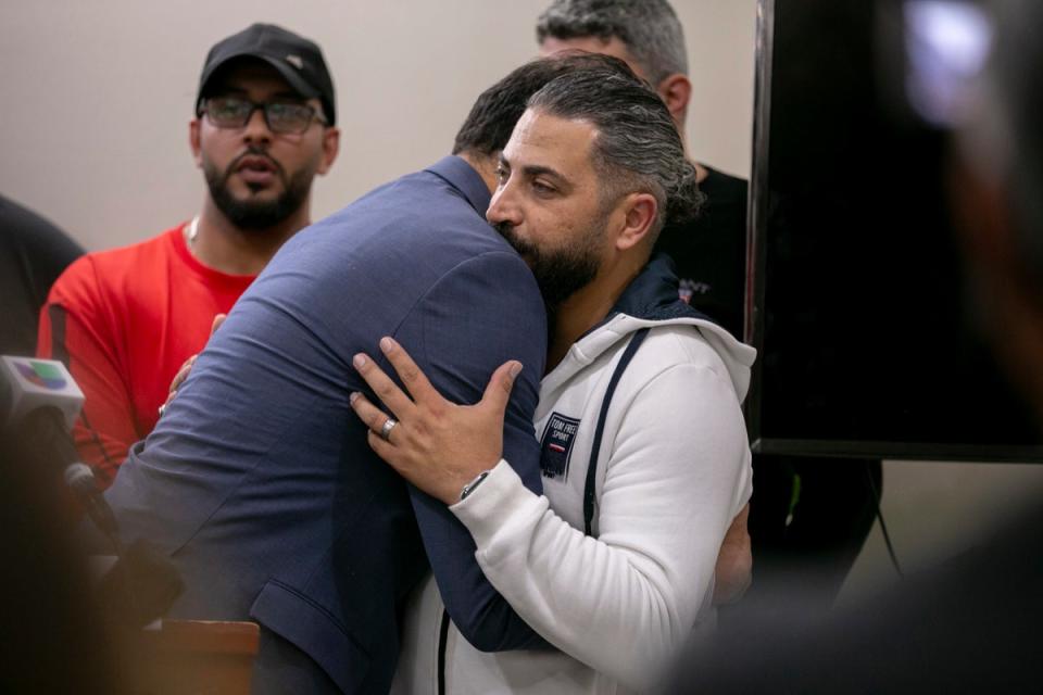 Wadea Al-Fayoume’s father is embraced during a press conference on Sunday. (2023 Sun Times)