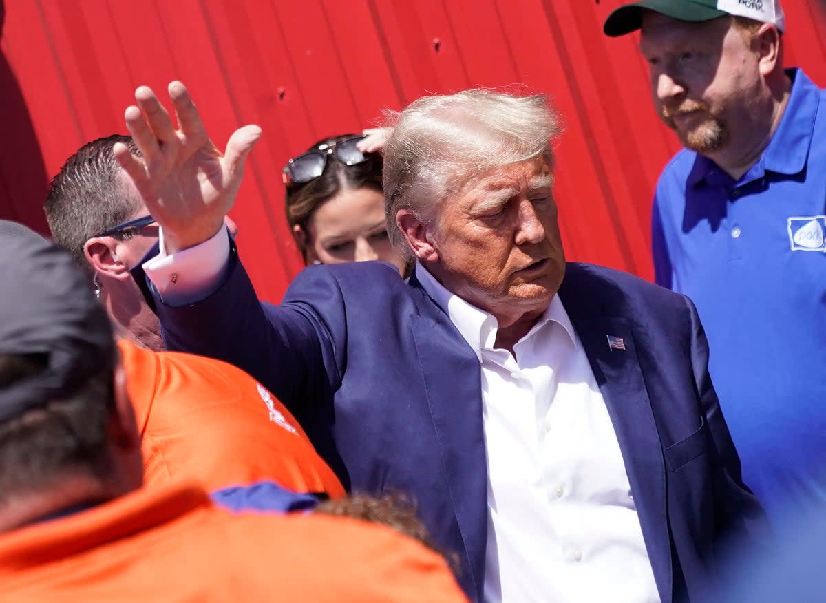 Former president and 2024 presidential hopeful Donald Trump visits the Iowa Pork Producers Tent during the Iowa State Fair in Des Moines on 12 August 2023 (AFP via Getty Images)