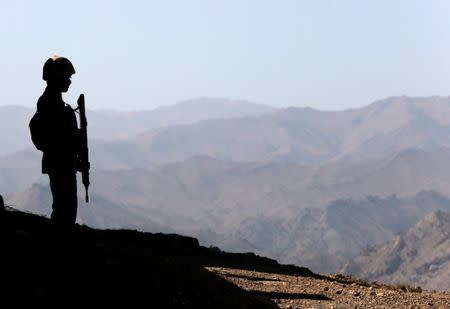 A soldier stands guard along the border fence outside the Kitton outpost on the border with Afghanistan in North Waziristan, Pakistan October 18, 2017. REUTERS/Caren Firouz