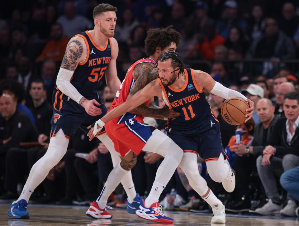 Apr 22, 2024; New York, New York, USA; New York Knicks guard Jalen Brunson (11) dribbles as Philadelphia 76ers guard Kelly Oubre Jr. (9) defends in front of center Isaiah Hartenstein (55) during the first half during game two of the first round for the 2024 NBA playoffs at Madison Square Garden. Mandatory Credit: Vincent Carchietta-USA TODAY Sports