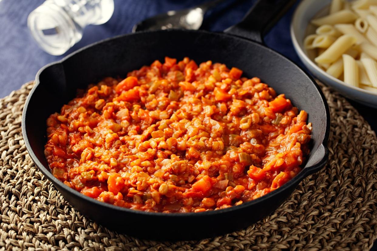 Homemade freshness vegan ragu made with lentils, barley, celery, and carrot with plain penne pasta