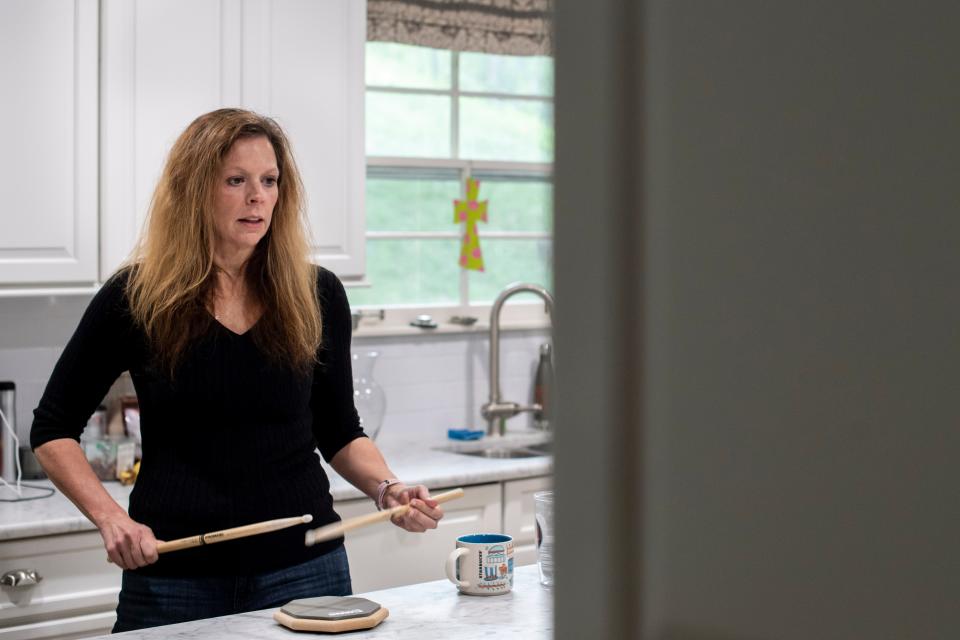 Julie McPeak, 51, practices in her kitchen on a drum paid at her home on Tuesday, April 6, 2021 in Nashville, Tenn. "COVID presented the perfect opportunity," says McPeak an attorney who started drum lessons during the pandemic. "It's very relaxing and sort of meditative to play," she went onto say. 