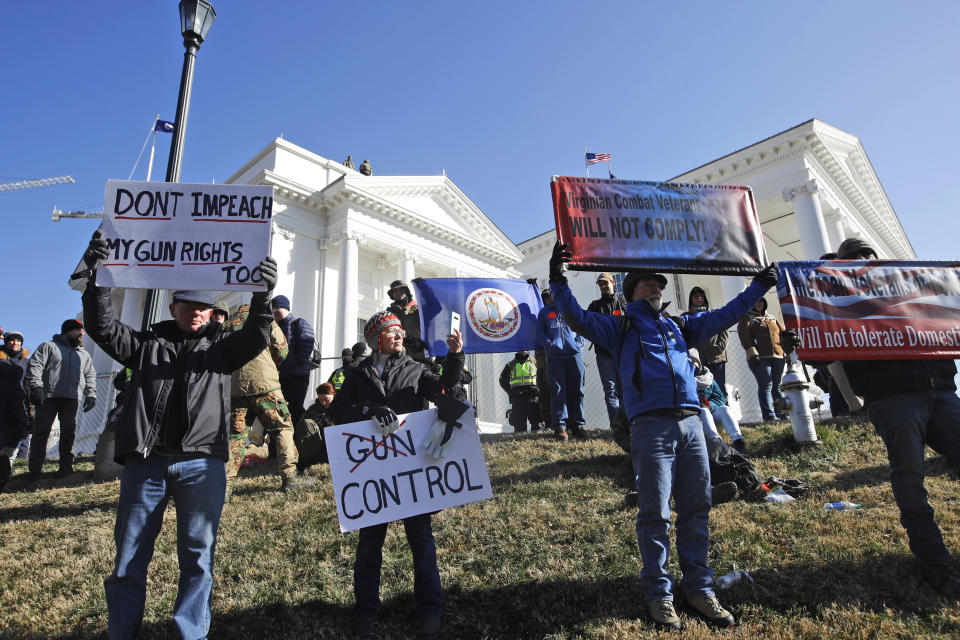 FILE - This Monday an. 20, 2020 file photo shows pro gun demonstrators holding signs in front of the Virginia State Capitol in Richmond, Va. In a state once synonymous with the Old South, Democrats are using their newfound legislative control to refashion Virginia as the region's progressive leader on racial, social and economic issues. (AP Photo/Steve Helber)