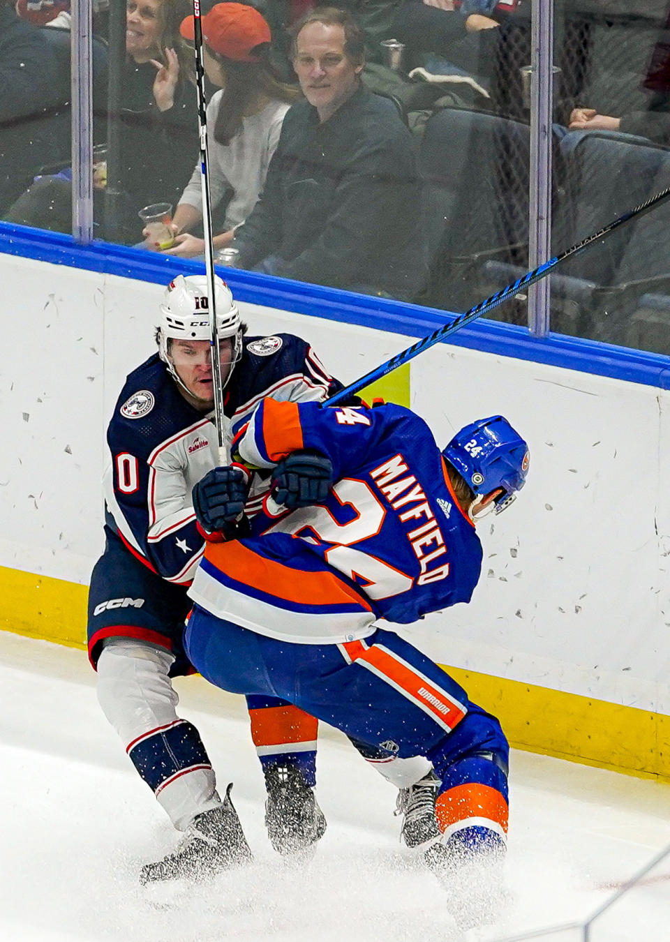 Columbus Blue Jackets left wing Dmitri Voronkov takes a hit from New York Islanders defenseman Scott Mayfield (24) during the first period of an NHL hockey game in Elmont, N.Y., Thursday, Dec. 7, 2023. (AP Photo/Peter K. Afriyie)