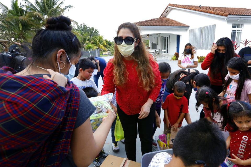 Nora Sandigo with a group of children.