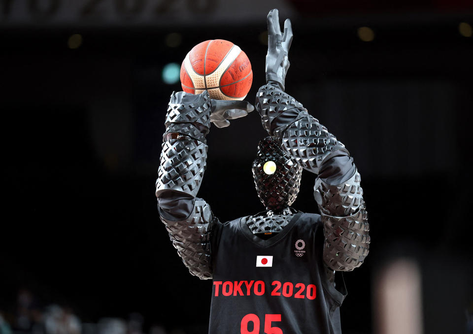 <p>A basketball-playing robot named CUE plays during halftime of the men's preliminary round group B game between the United States and France on July 25.</p>