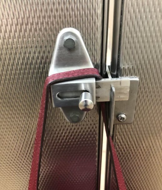 A bag hanging on a bathroom door lock