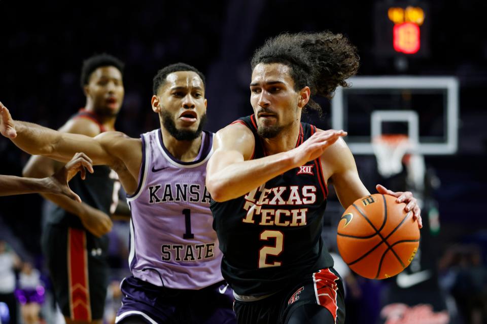 Texas Tech guard Pop Isaacs (2) attempts to score against Kansas State guard Markquis Nowell (1) during the first half of an NCAA college basketball game on Saturday, Jan. 21, 2023, in Manhattan, Kan. (AP Photo/Colin E. Braley)