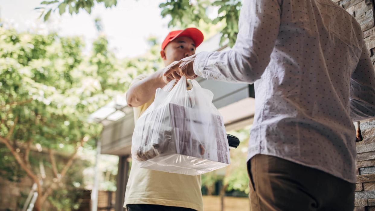 Delivery man bringing food to a customer.