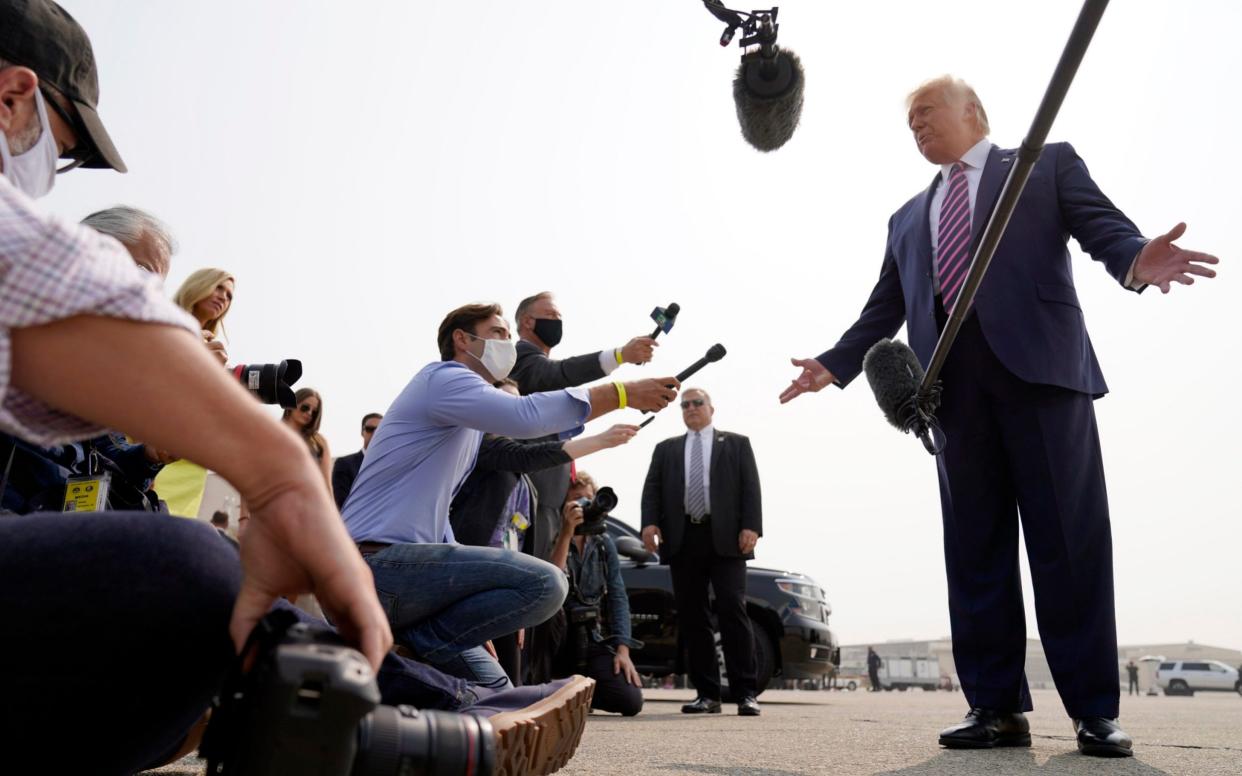 Donald Trump speaks to reporters as he arrives at Sacramento McClellan Airport - Andrew Harnik /AP