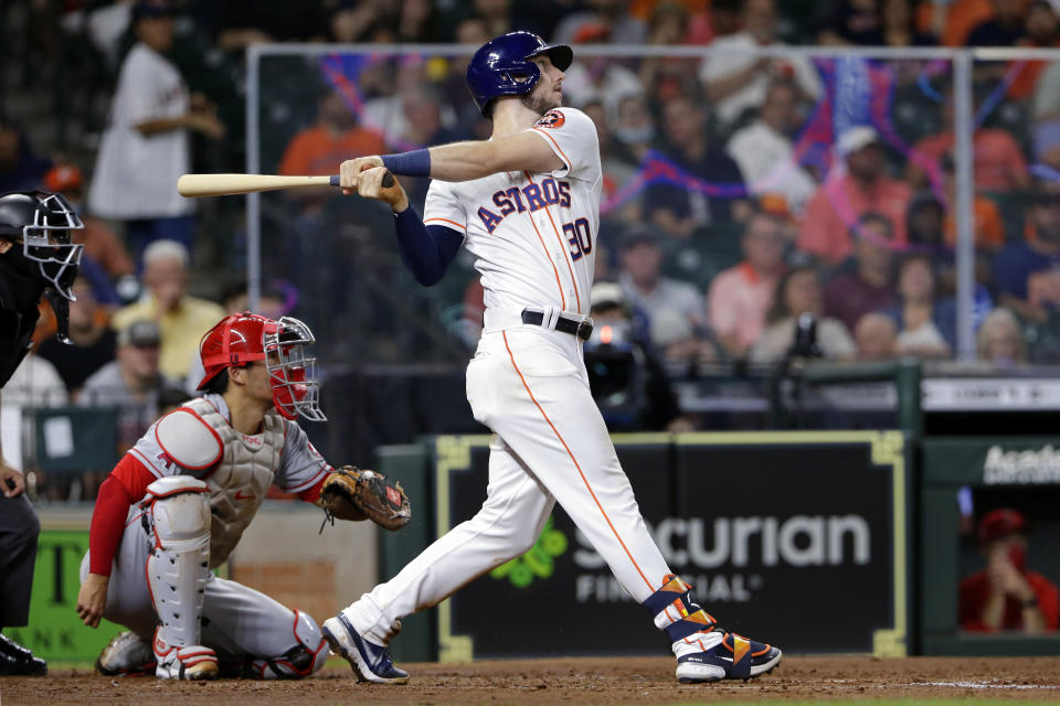 Houston Astros' Kyle Tucker (30) watches his home run in front of Los Angeles Angels catcher Kurt Suzuki, left, during the fifth inning of a baseball game Tuesday, May 11, 2021, in Houston. (AP Photo/Michael Wyke)