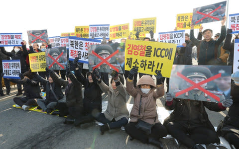 South Korean protesters tried to block the motorcade of Kim Yong Chol - Credit: Reuters