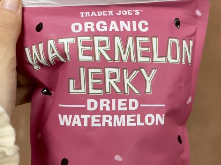 hand holding bag of trader joes watermelon jerky