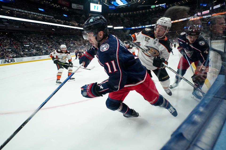 Oct 24, 2023; Columbus, Ohio, USA; Columbus Blue Jackets center Adam Fantilli (11) moves the puck around Anaheim Ducks left wing Ross Johnston (44) during the first period of the NHL game at Nationwide Arena.