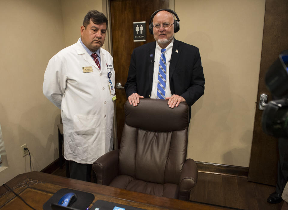 CDC director Robert Redfield, right, tests out the bluetooth stethoscope inside a telemedicine room at the Medical Advocacy and Outreach clinic in Montgomery, Ala. on Friday, June 14, 2019. (Jake Crandall/Montgomery Advertiser via AP)