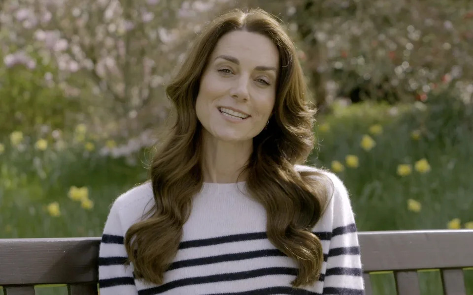 The Princess speaking in a garden, sitting on a bench, wearing a Breton jersey