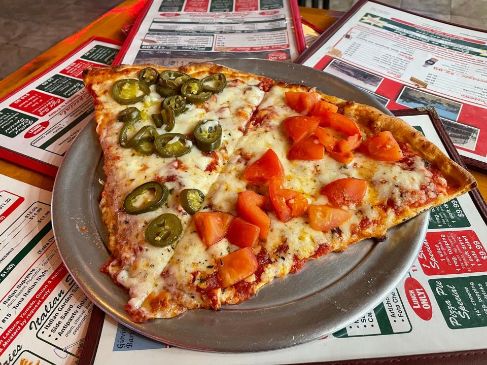 The two-slice lunch special with jalapenos and fresh tomatoes at Peppino's Pizzeria in Athens, Ga. on Thursday, Nov. 16, 2023.