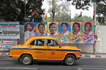 A taxi drives past a poster of Mamata Banerjee, Chief Minister of West Bengal state, in Kolkata, February 9, 2019. REUTERS/Rupak De Chowdhuri/Files