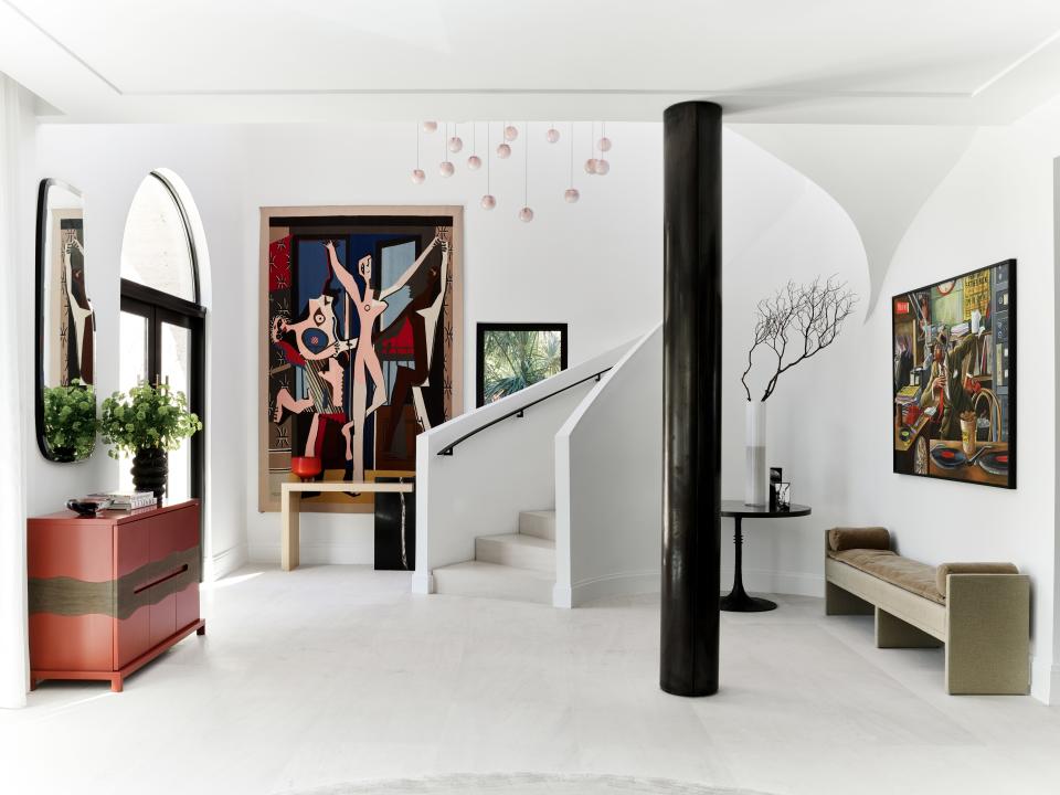 Wecselman designed Joyner’s foyer to act as a mini art gallery. Pieces include a Picasso tapestry and a specially commissioned piece by Ernie Barnes. Since Joyner adores the color red, Wecselman also custom designed a cabinet for him in a vibrant shade. The pendant lights were also custom, from Bocci.
