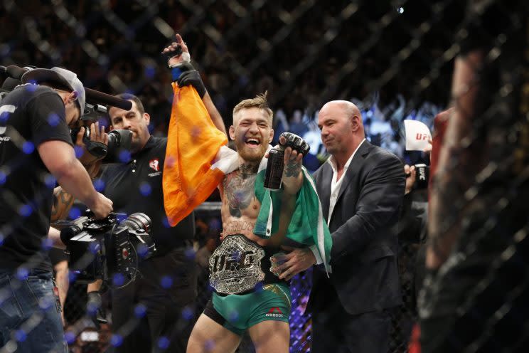 Conor McGregor celebrates after winning the featherweight title at UFC 194. (AP)