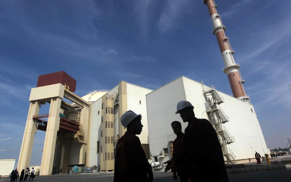  Iranian workers stand in front of Bushehr nuclear power plant 1,200 km south of Tehran - REUTERS