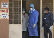 A member of a delegation from Indian health ministry, center, interacts with the medical superintendent outside of an isolation ward for people who returned from China and under observation at the Government Fever Hospital in Hyderabad, India, Tuesday, Jan. 28, 2020. Countries with citizens in the central Chinese city that's the epicenter of a viral outbreak are planning evacuations as the number of illnesses grow and China takes drastic measures to try to stop the spread of the virus. (AP Photo/Mahesh Kumar A.)