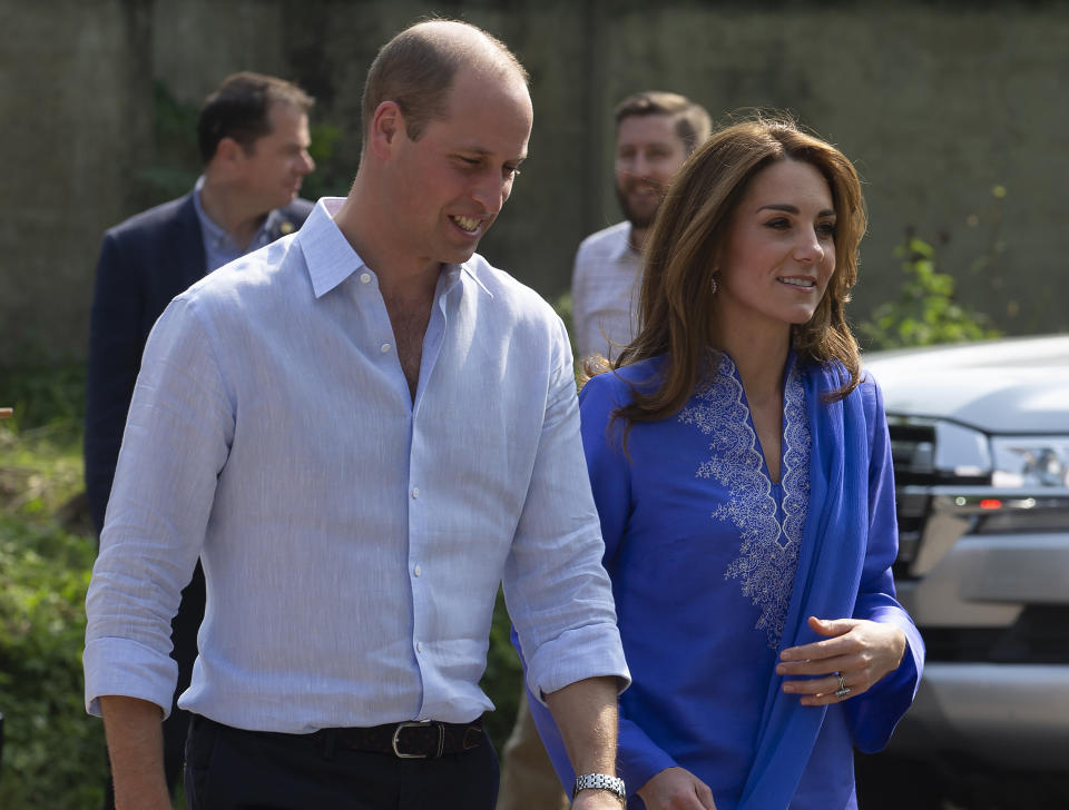 Wearing a traditional Pakistani dress called a Kurta, walks with Prince William as they arrive at a school outside of Islamabad, Pakistan, Tuesday, Oct. 15, 2019. The Duke and Duchess of Cambridge, who are strong advocates of girls' education were greeted by teachers and children. (AP Photo/B.K. Bangash)