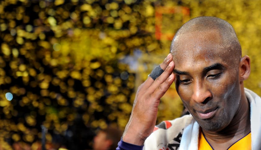 Lakers star Kobe Bryant pauses for a moment as confetti streams down at the Staples Center following his final game on April 13, 2016.