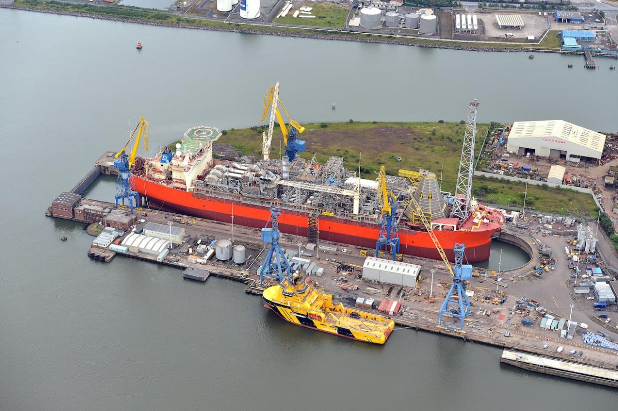 The SeaRose FPSO, which is used to produce, store and offload oil from the White Rose field in offshore Newfoundland, will depart for a shipyard in Ireland this month. The production vessel is seen here in a 2012 photo during a previous refit at the same shipyard. (Cenovus - image credit)