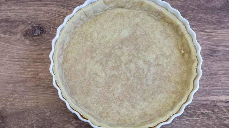 partially baked quiche in a pan