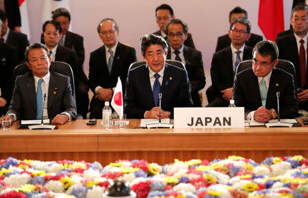 Japan's Prime Minister Shinzo Abe, flanked by Finance Minister Taro Aso and Foreign Minister Taro Kono, attends at their trilateral summit with South Korea's President Moon Jae-in and Chinese Premier Li Keqiang (not in picture) at Akasaka Palace state guest house in Tokyo, Japan May 9, 2018. REUTERS/Kim Kyung-Hoon/Pool