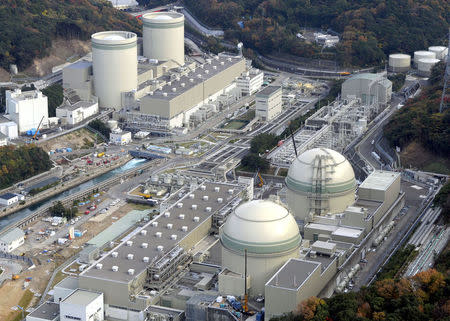 FILE PHOTO: An aerial view shows No. 4 (front L), No. 3 (front R), No. 2 (rear L) and No. 1 reactor buildings at Kansai Electric Power Co.'s Takahama nuclear power plant in Takahama town, Fukui prefecture, in this photo taken by Kyodo November 27, 2014. Mandatory credit. REUTERS/Kyodo/File Photo