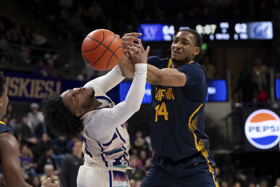 California forward Grant Newell, right, and Washington guard Sahvir Wheeler vie for the ball during the second half of an NCAA college basketball game Saturday, Feb. 17, 2024, in Seattle. California won 82-80. (AP Photo/Stephen Brashear)