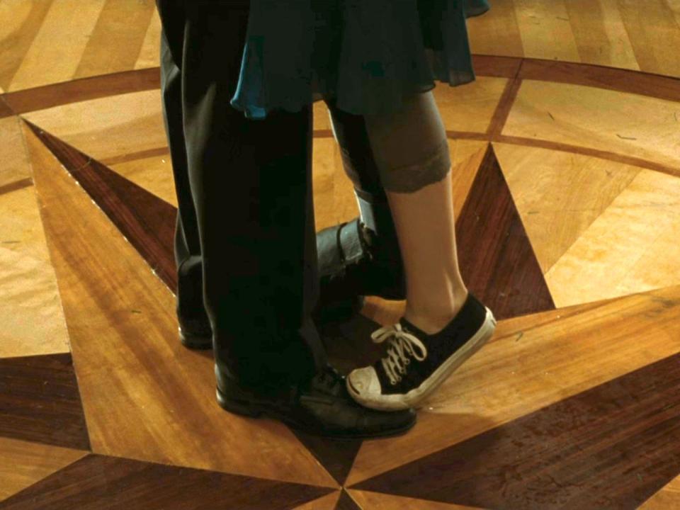 Edward Cullen wearing black dress shoes and Bella Swan wearing a Converse sneaker in "Twilight."