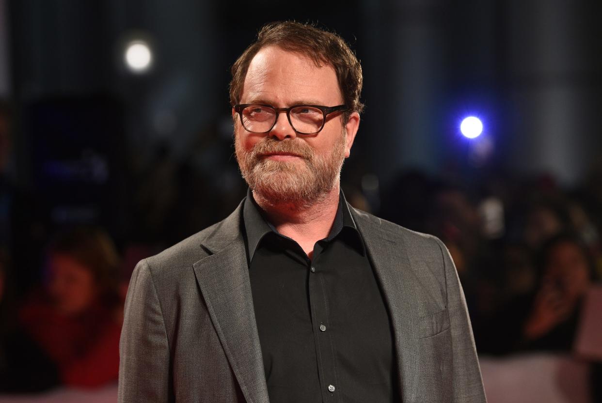 actor Rainn Wilson smiling on a red carpet