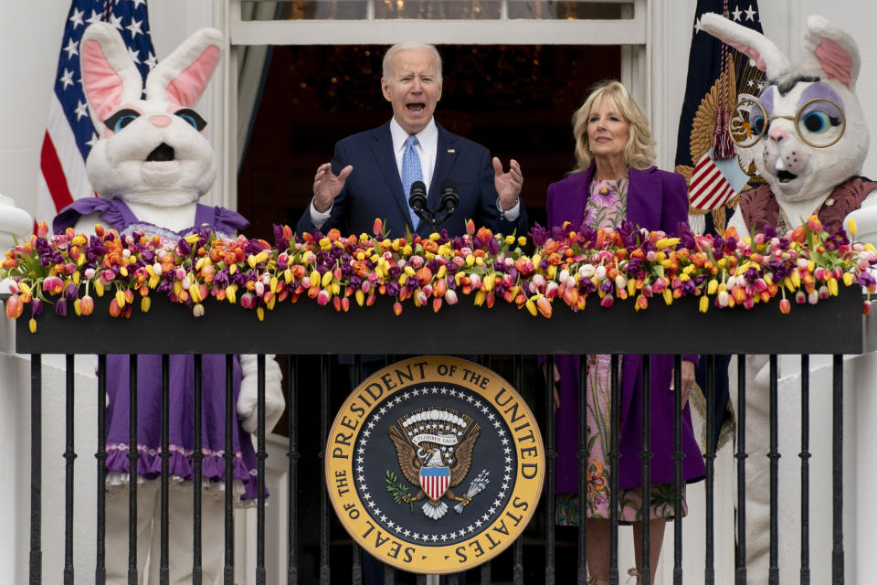 FILE - President Joe Biden, accompanied by first lady Jill Biden and Easter Bunnies, speaks on the Blue Room balcony at the White House during the White House Easter Egg Roll, April 18, 2022, in Washington. (AP Photo/Andrew Harnik, File)