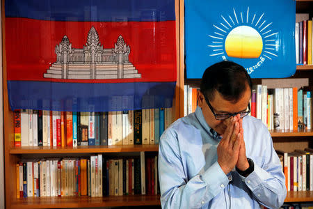 Former president of the dissolved opposition Cambodia National Rescue Party (CNRP) Sam Rainsy, who is living in exile, salutes after an online live statement in Paris, France, July 19, 2018. REUTERS/Philippe Wojazer