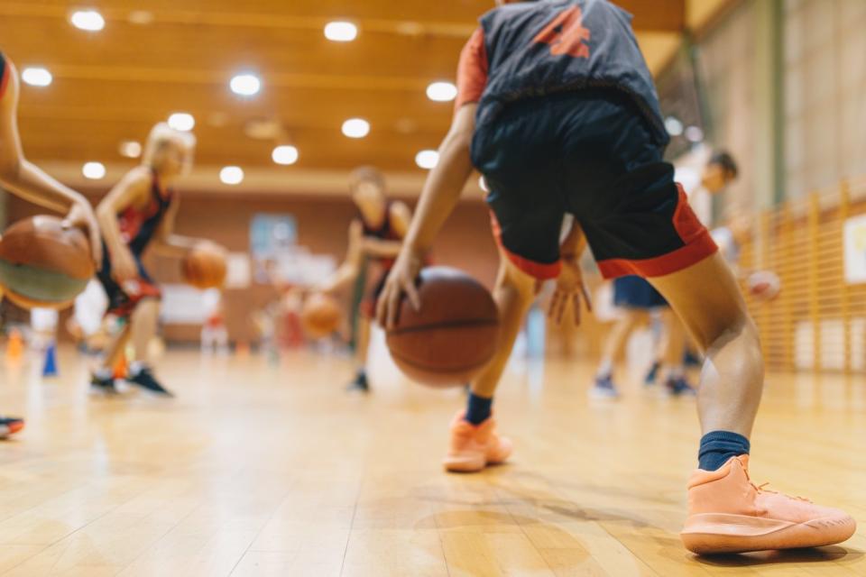 Basketball with a focus on the shoes.